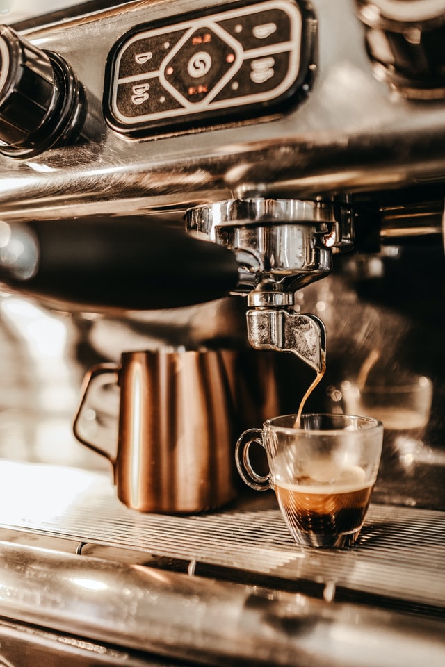 coffee espresso machine pouring a coffee in a cup